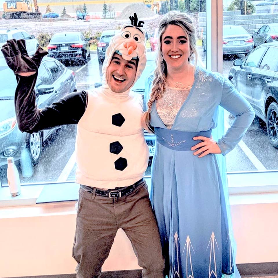 Two Geotab employees dressed up in Christmas Costumes.