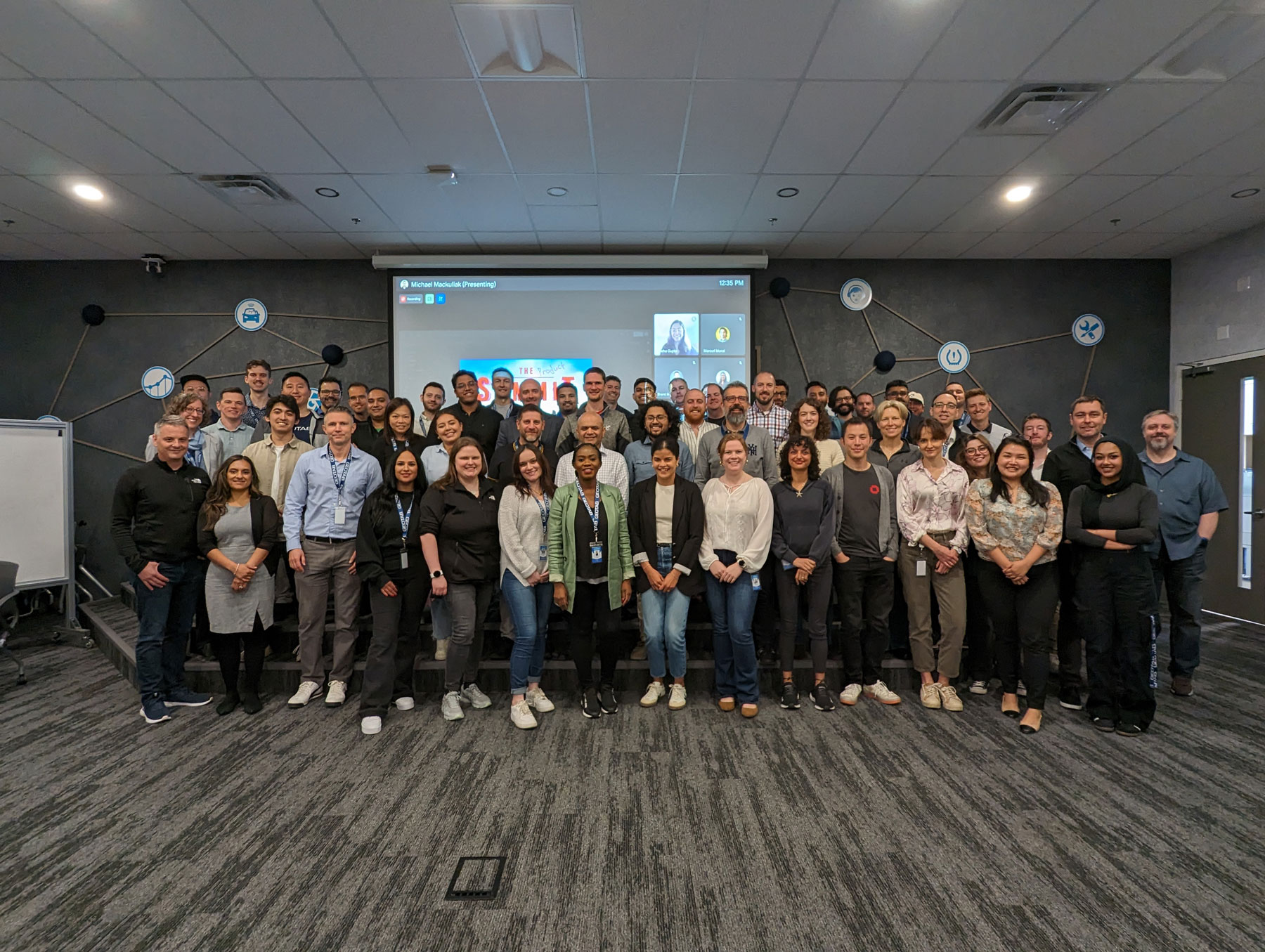 A group of Geotabbers posing for a photo in a conference room