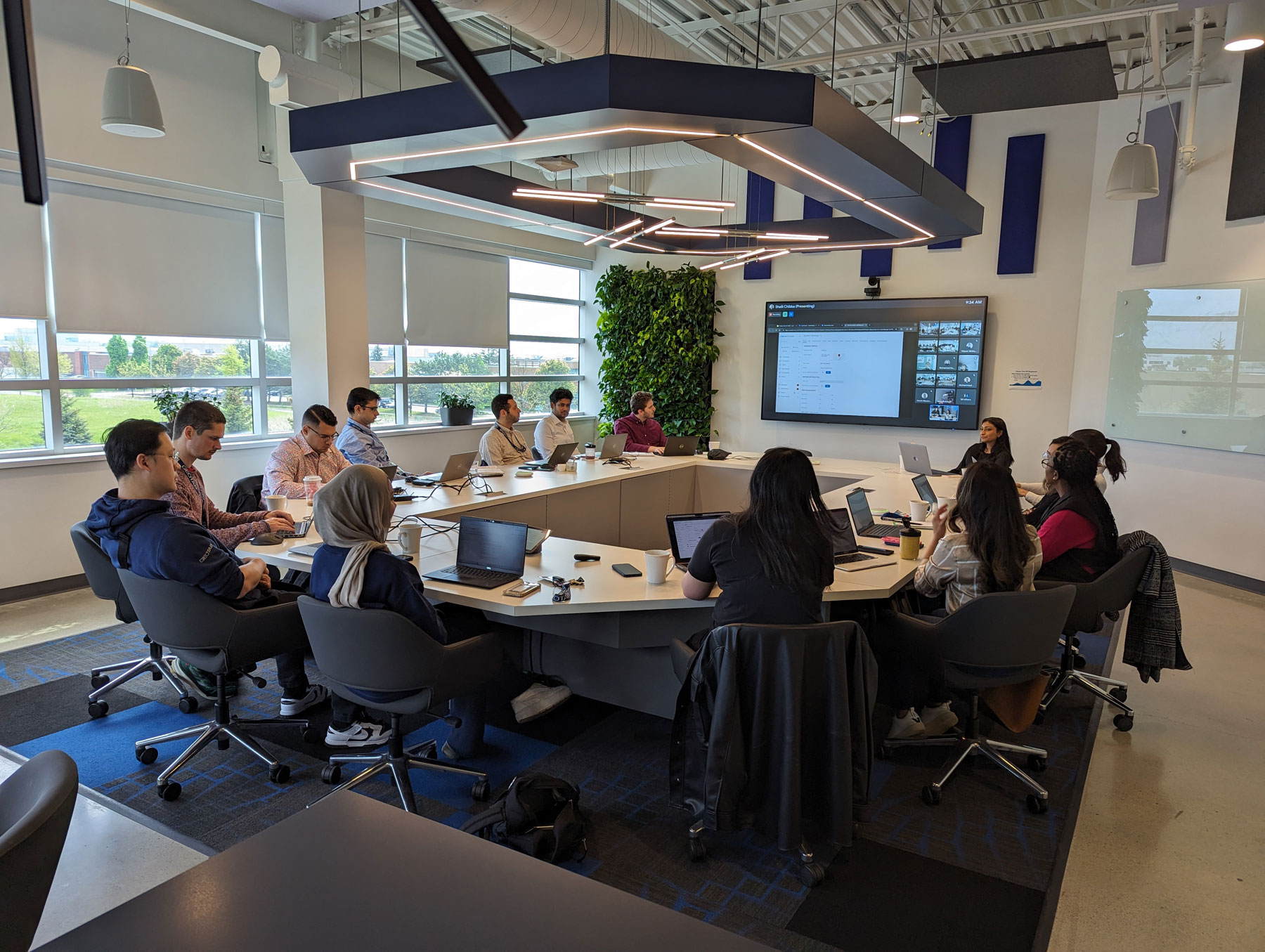 A team of Geotabbers working on laptops around a large conference table