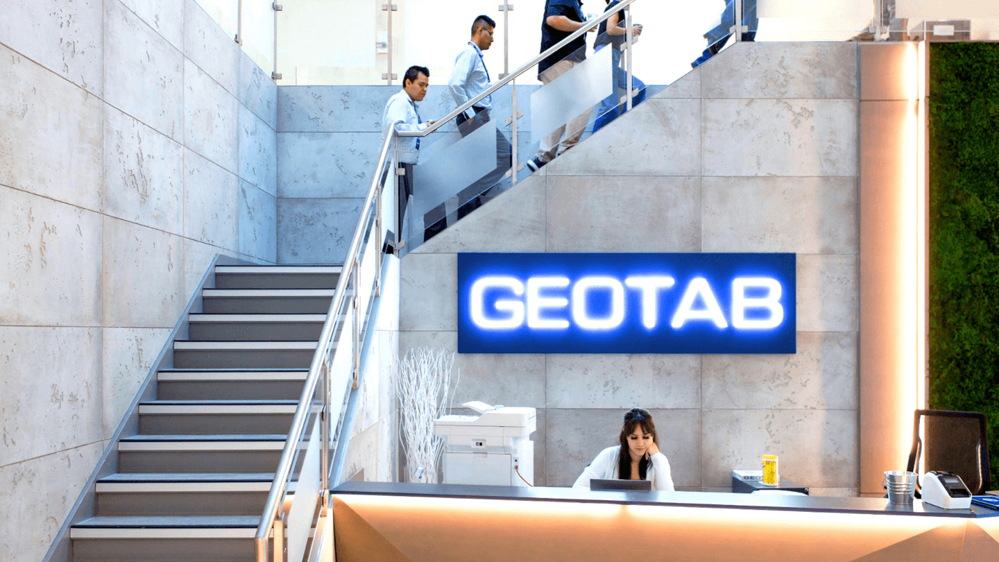 A large white two story office building with the word Geotab on it.