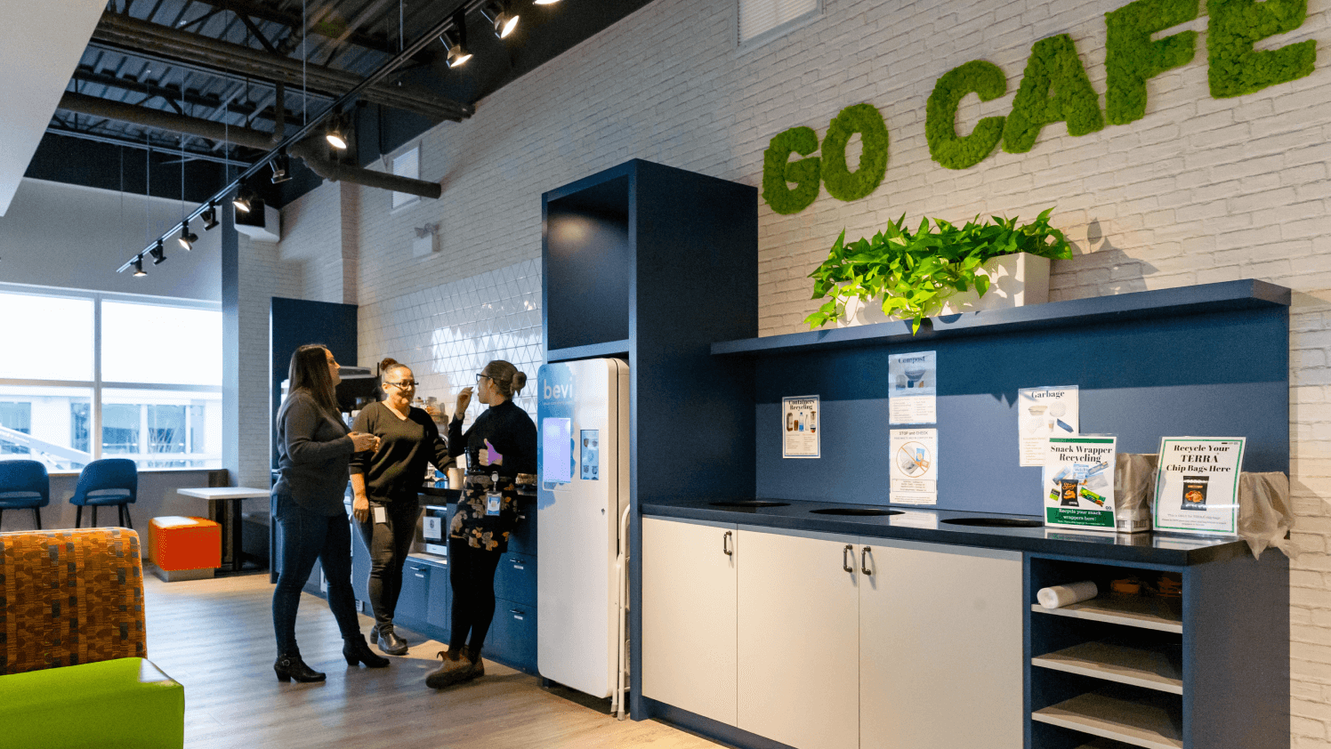 An image of the Geotab Cafe with two people standing and talking