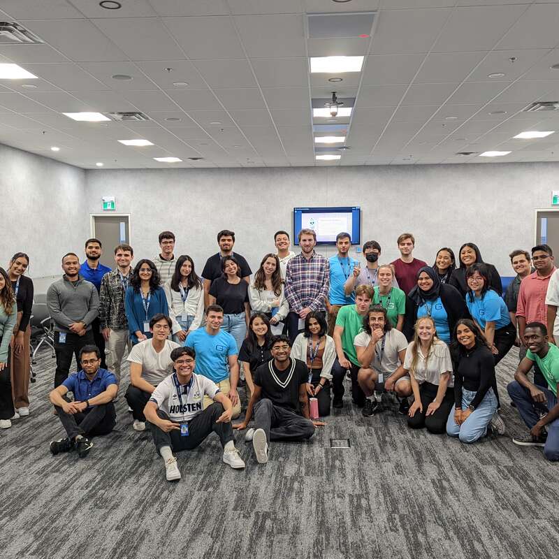 Many people gathered together for a photo in one of the offices.